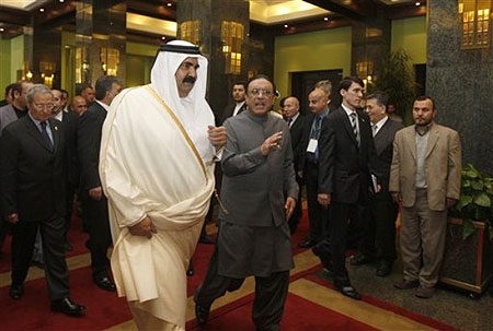 Emir of Qatar, Sheikh Hamad bin Khalifa al Thani, center, talks with Pakistani President Asif Ali Zardari, center right, as they arrive to attend in a summit of the Economic Cooperation Organization (ECO) in Tehran, Iran on Wednesday March, 11, 2009